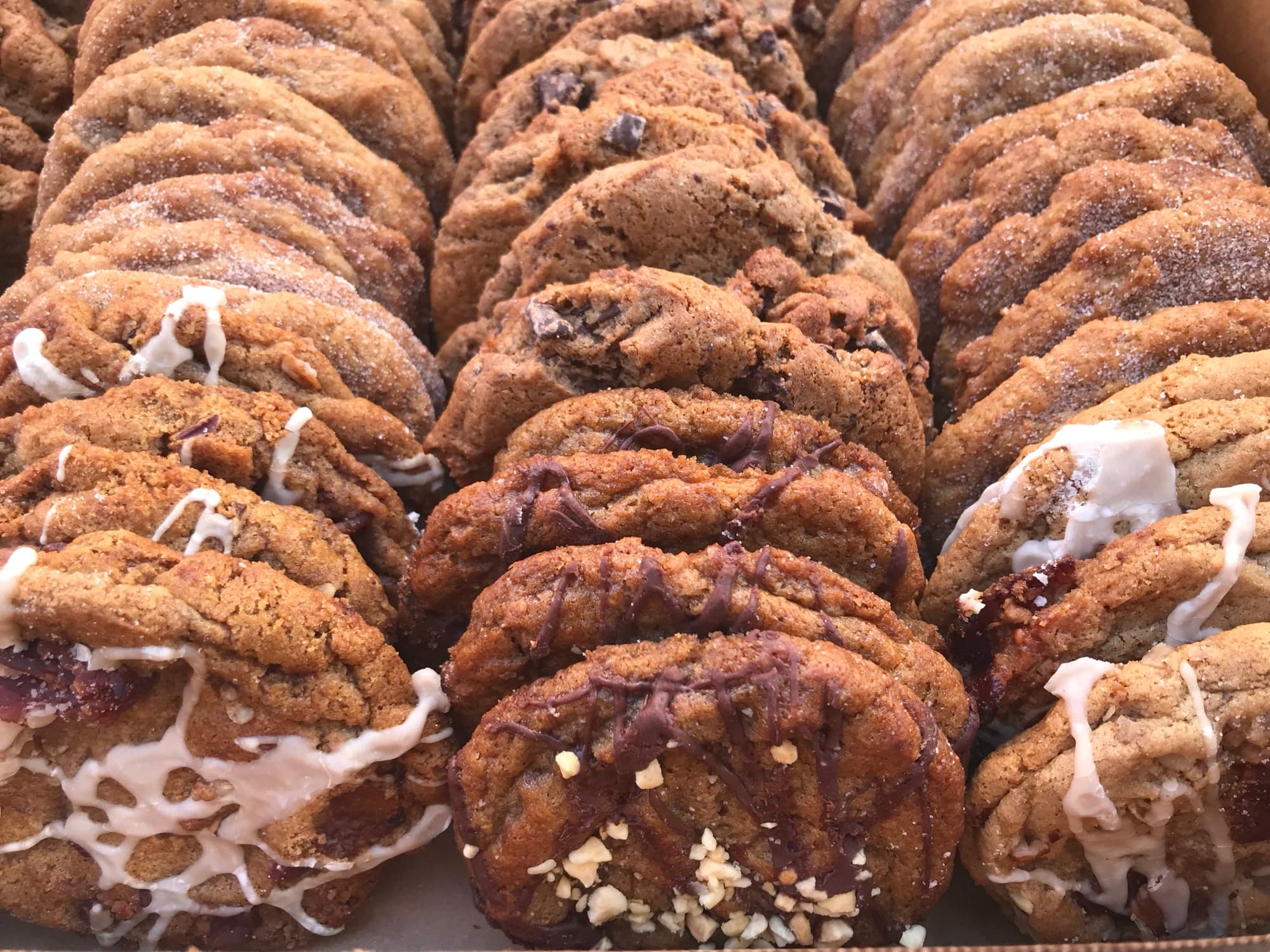 Rows of assorted Chunk-N-Chip cookies with chocolate pieces and icing
