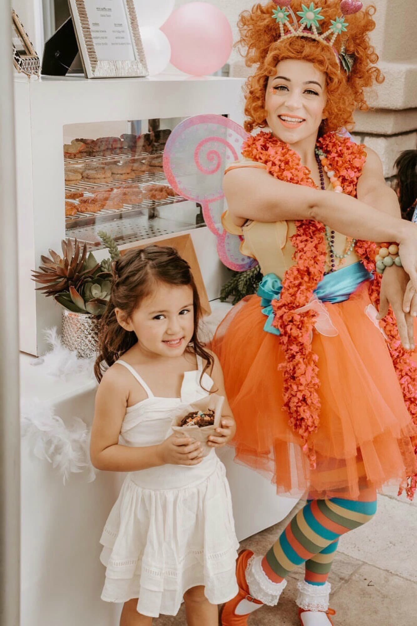 Costumed entertainer handing a Chunk-N-Chip treat to a young guest at a birthday party