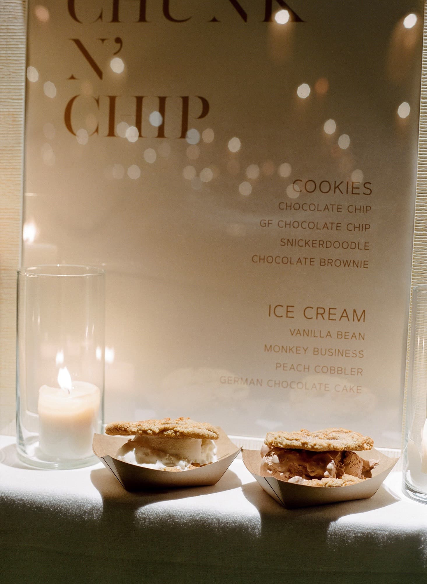 Candlelit Chunk-N-Chip dessert menu with two ice cream sammiches at a wedding